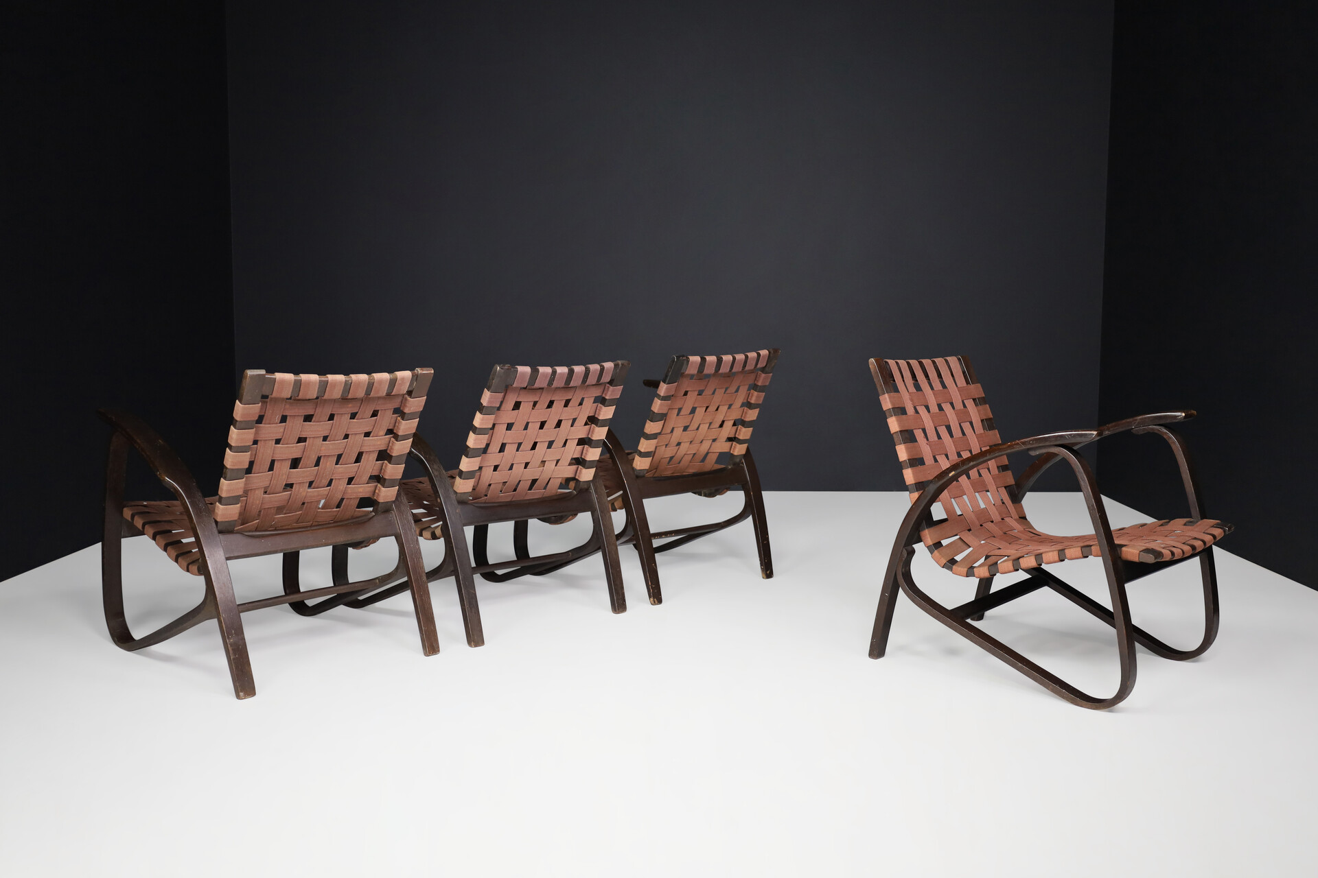 Bauhaus Lounge chairs in dark bentwood and woven straps by Jan Vanek, Czech Republic, 1930s. Mid-20th century