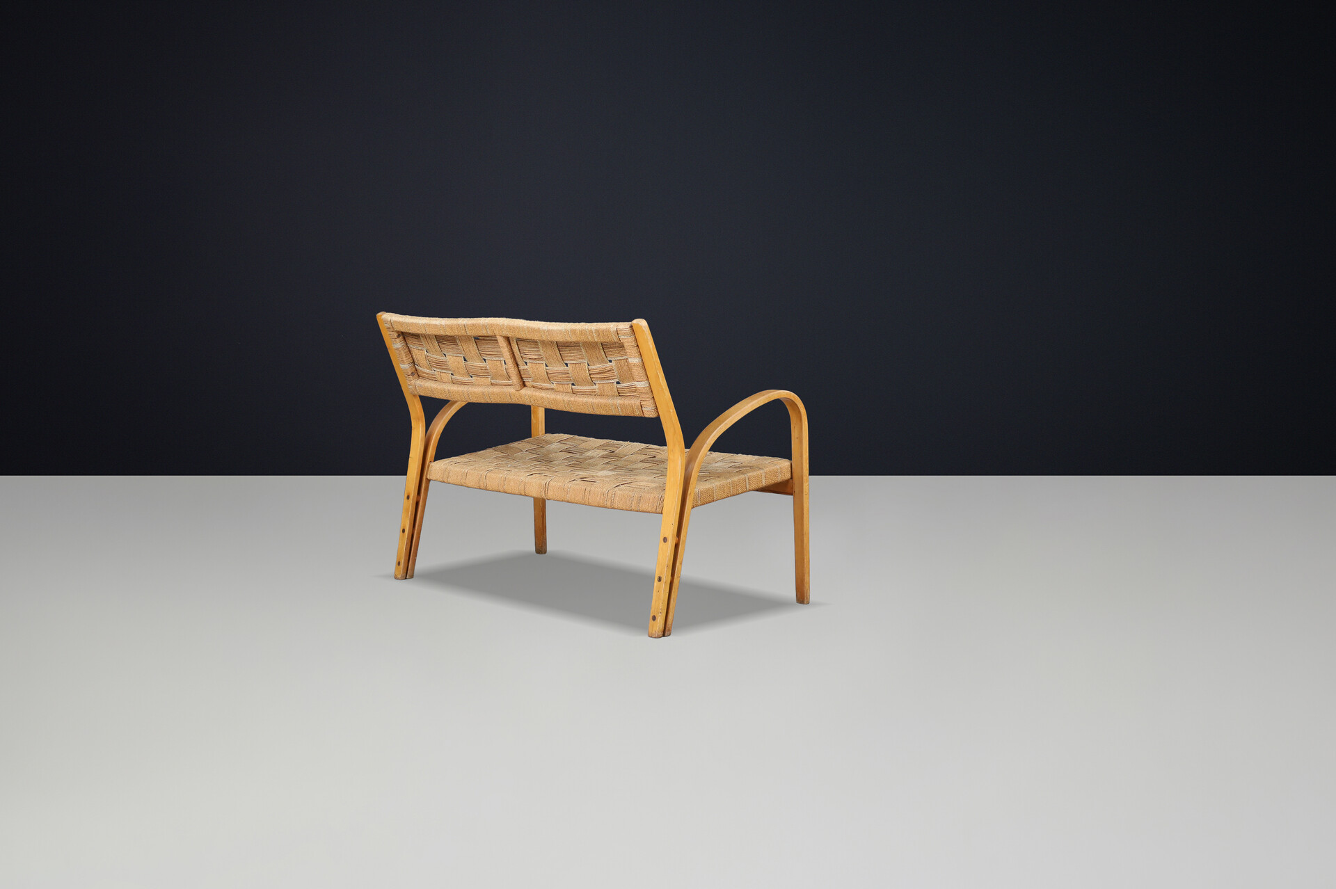 Bench by Augusto Romano, Italy, 1940s.  Bent plywood with braided rope with wonderful patina and curved shape. Mid-20th century