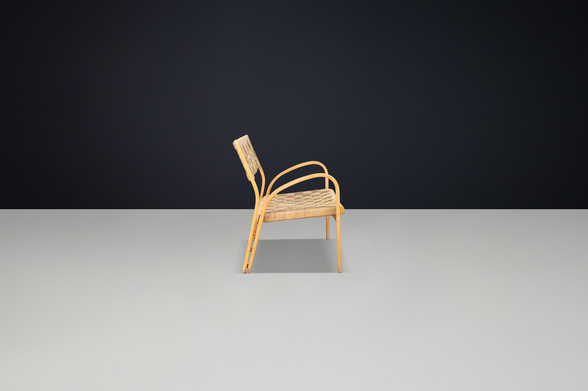 Bench by Augusto Romano, Italy, 1940s.  Bent plywood with braided rope with wonderful patina and curved shape. Mid-20th century