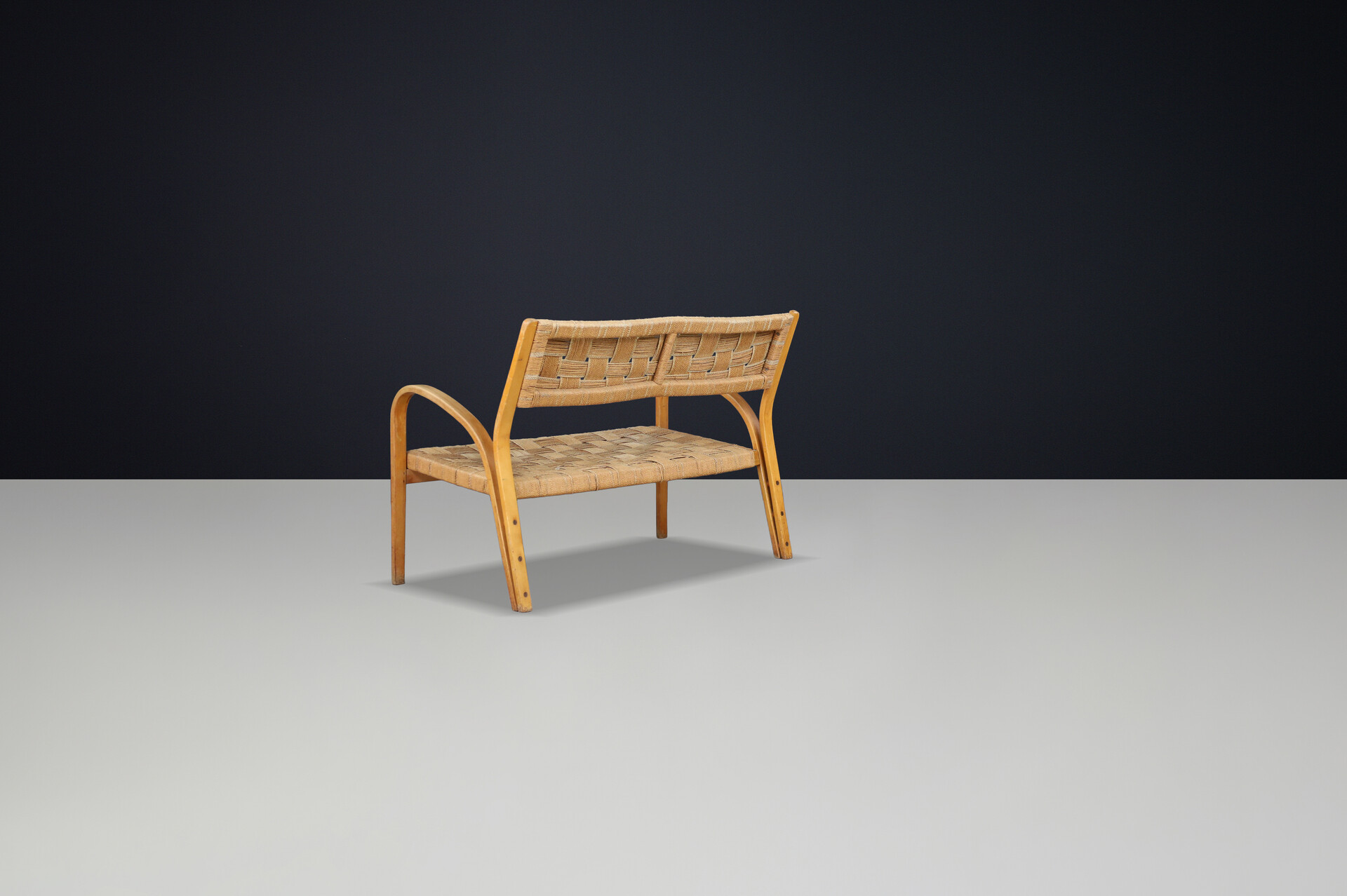 Bench by Augusto Romano, Italy, 1940s.  Bent plywood with braided rope with wonderful patina and curved shape. Mid-20th century