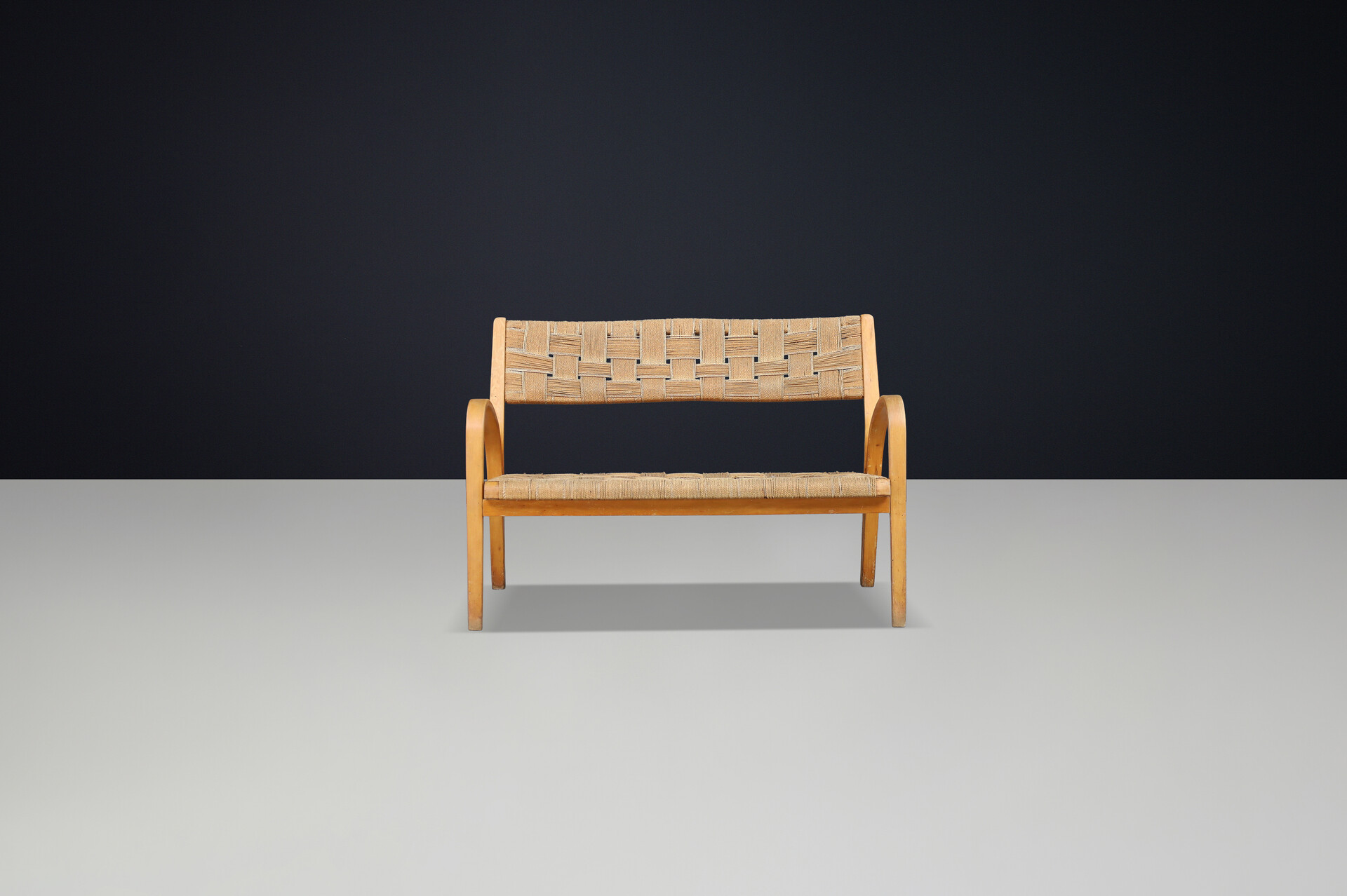 Bench by Augusto Romano, Italy, 1940s.  Bent plywood with braided rope with wonderful patina and curved shape. Mid-20th century