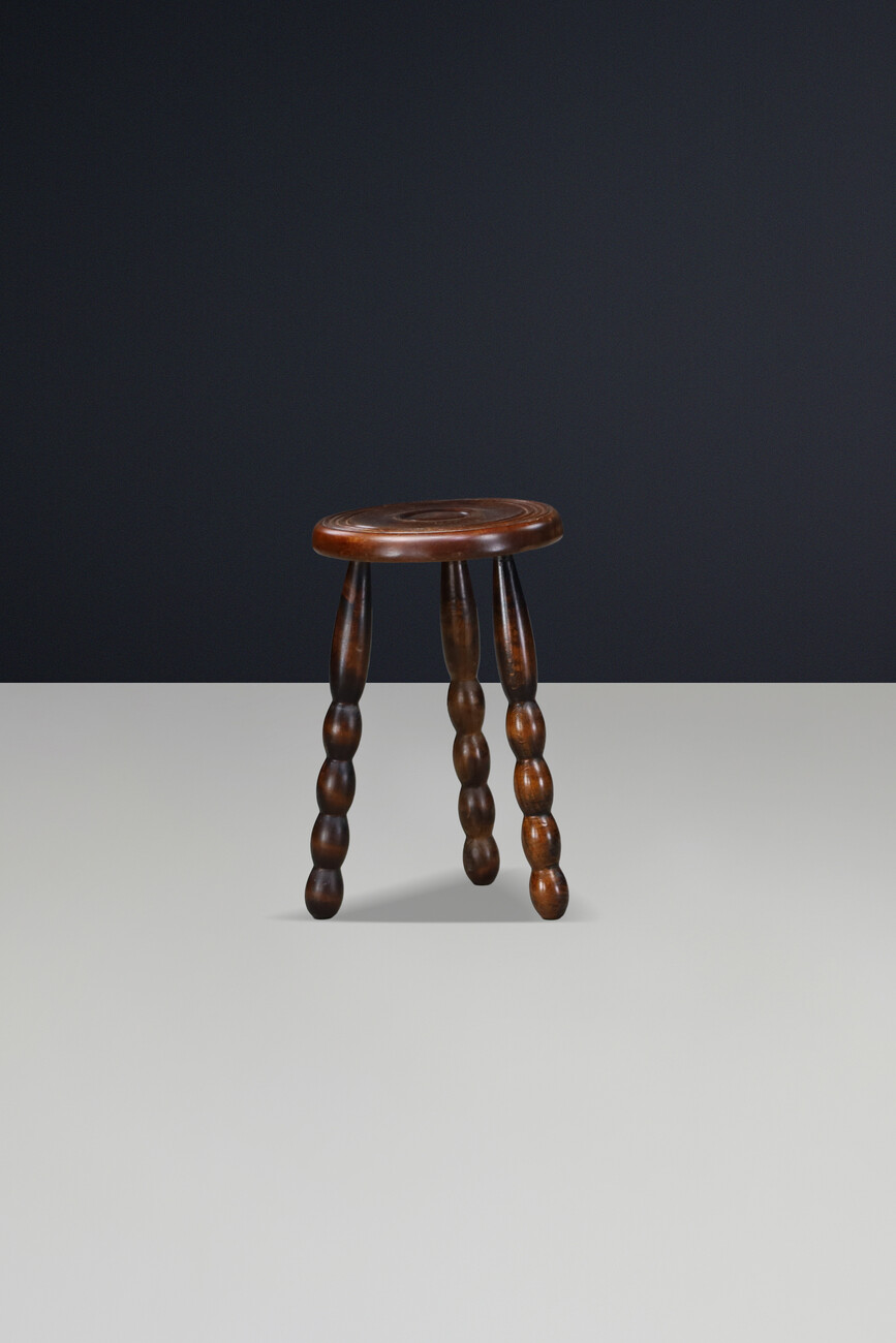 Brutalist Sculptural pair of French Brutalist stools crafted in solid walnut, designed in the manner of Charles Dudouyt, France, circa 1940s. Mid-20th century