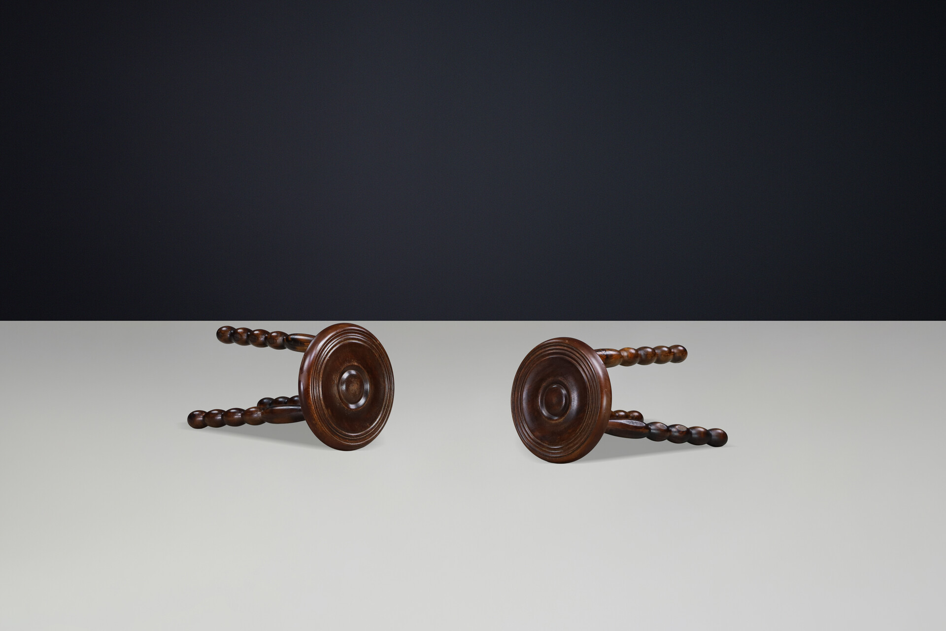 Brutalist Sculptural pair of French Brutalist stools crafted in solid walnut, designed in the manner of Charles Dudouyt, France, circa 1940s. Mid-20th century