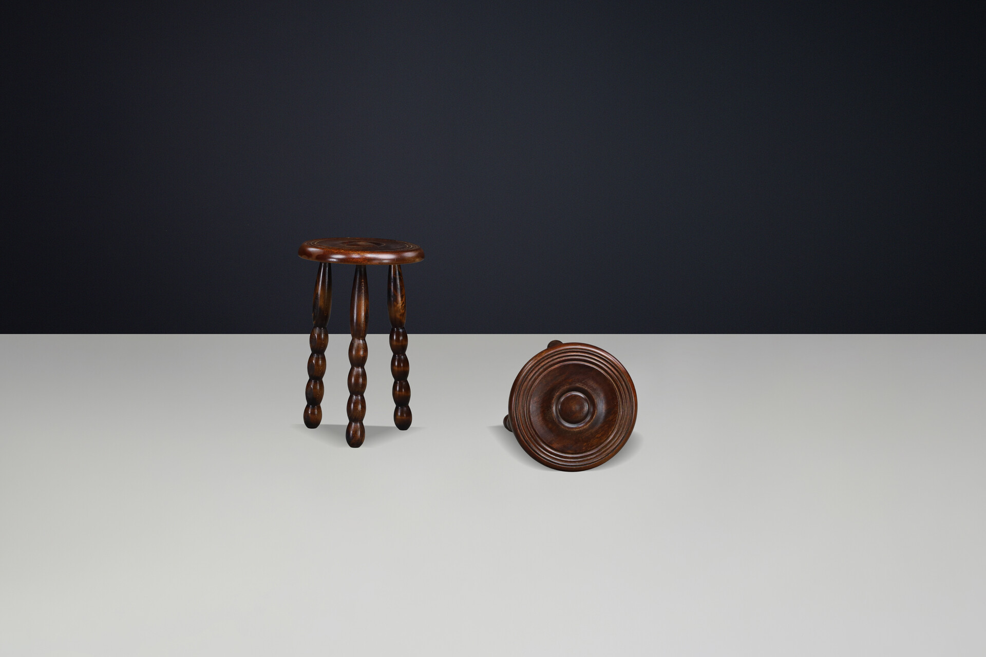 Brutalist Sculptural pair of French Brutalist stools crafted in solid walnut, designed in the manner of Charles Dudouyt, France, circa 1940s. Mid-20th century