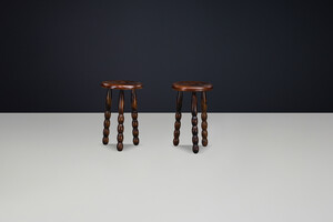 Brutalist Sculptural pair of French Brutalist stools crafted in solid walnut, designed in the manner of Charles Dudouyt, France, circa 1940s. Mid-20th century