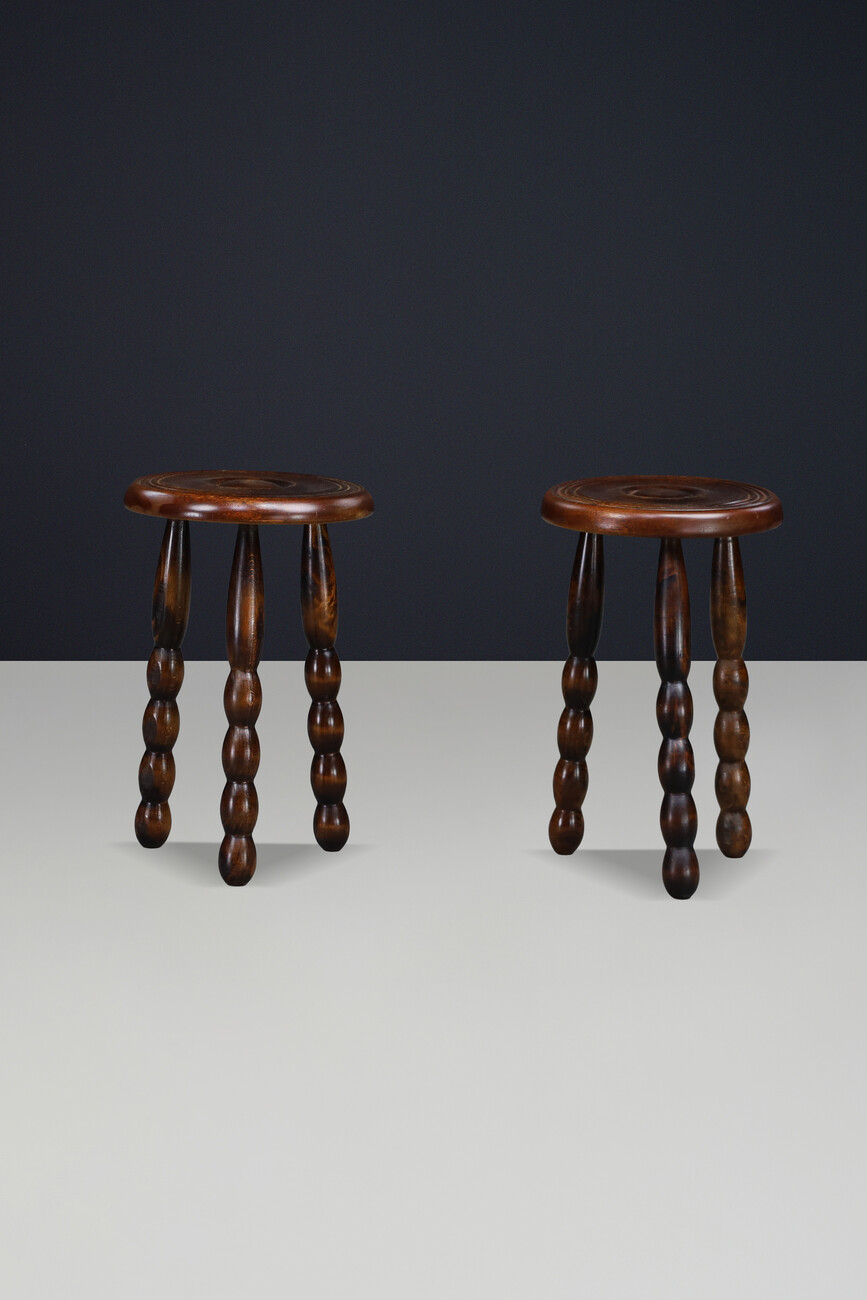 Brutalist Sculptural pair of French Brutalist stools crafted in solid walnut, designed in the manner of Charles Dudouyt, France, circa 1940s. Mid-20th century