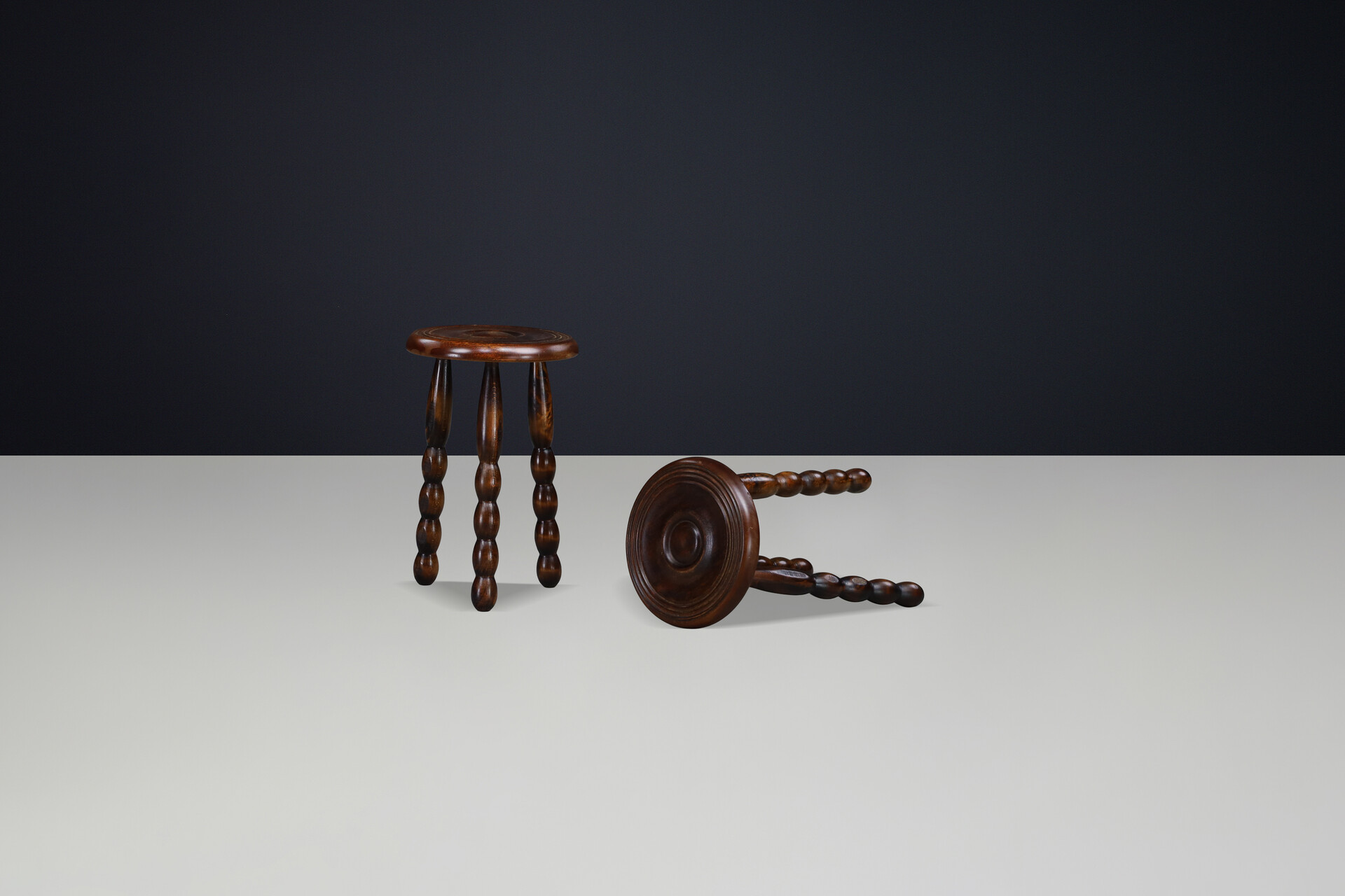 Brutalist Sculptural pair of French Brutalist stools crafted in solid walnut, designed in the manner of Charles Dudouyt, France, circa 1940s. Mid-20th century