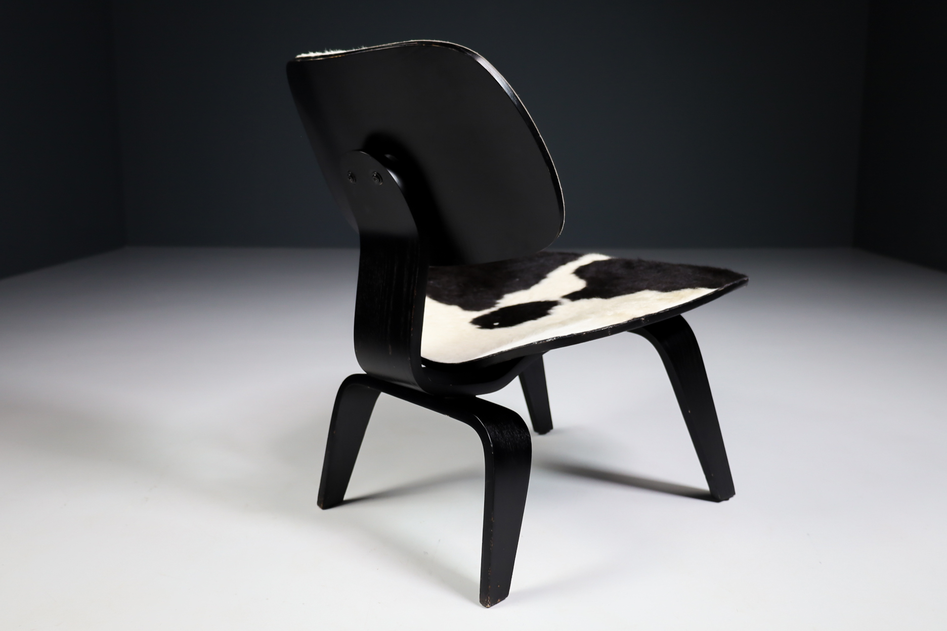 Mid century modern Charles & Ray Eames Design LCW Lounge Chair with black and withe cowhide Late-20th century