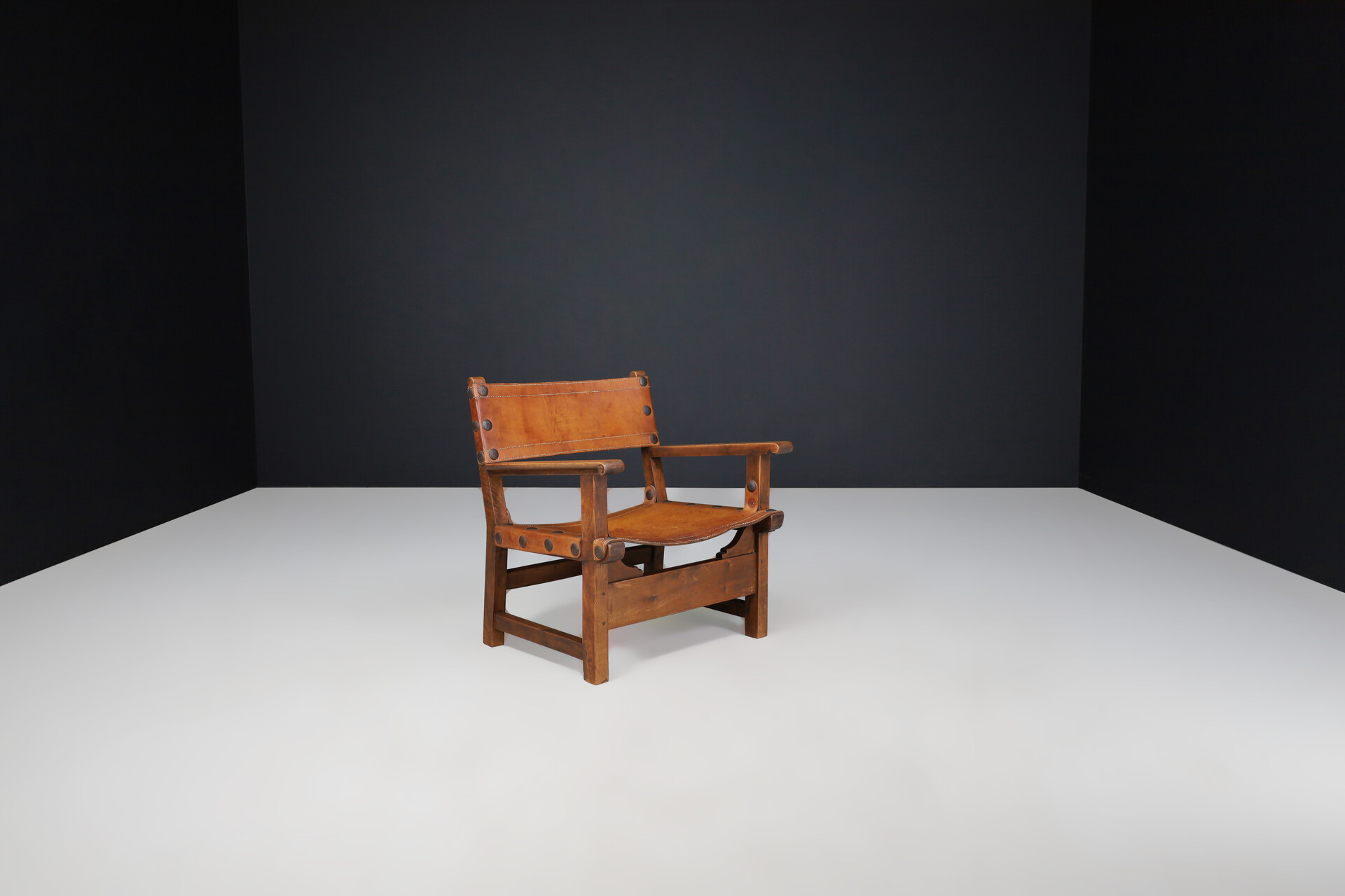 Mid century modern Patinated cognac leather and wood lounge chair, France 1960s Mid-20th century