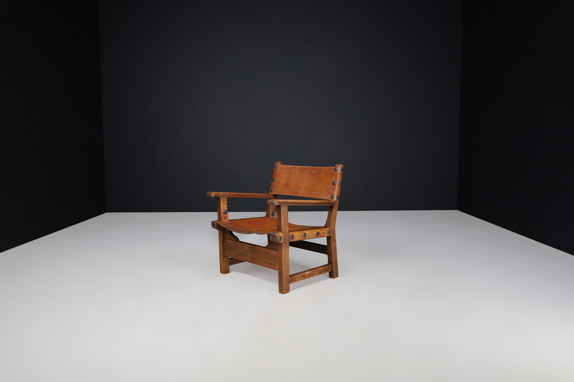 Mid century modern Patinated cognac leather and wood lounge chair, France 1960s Mid-20th century