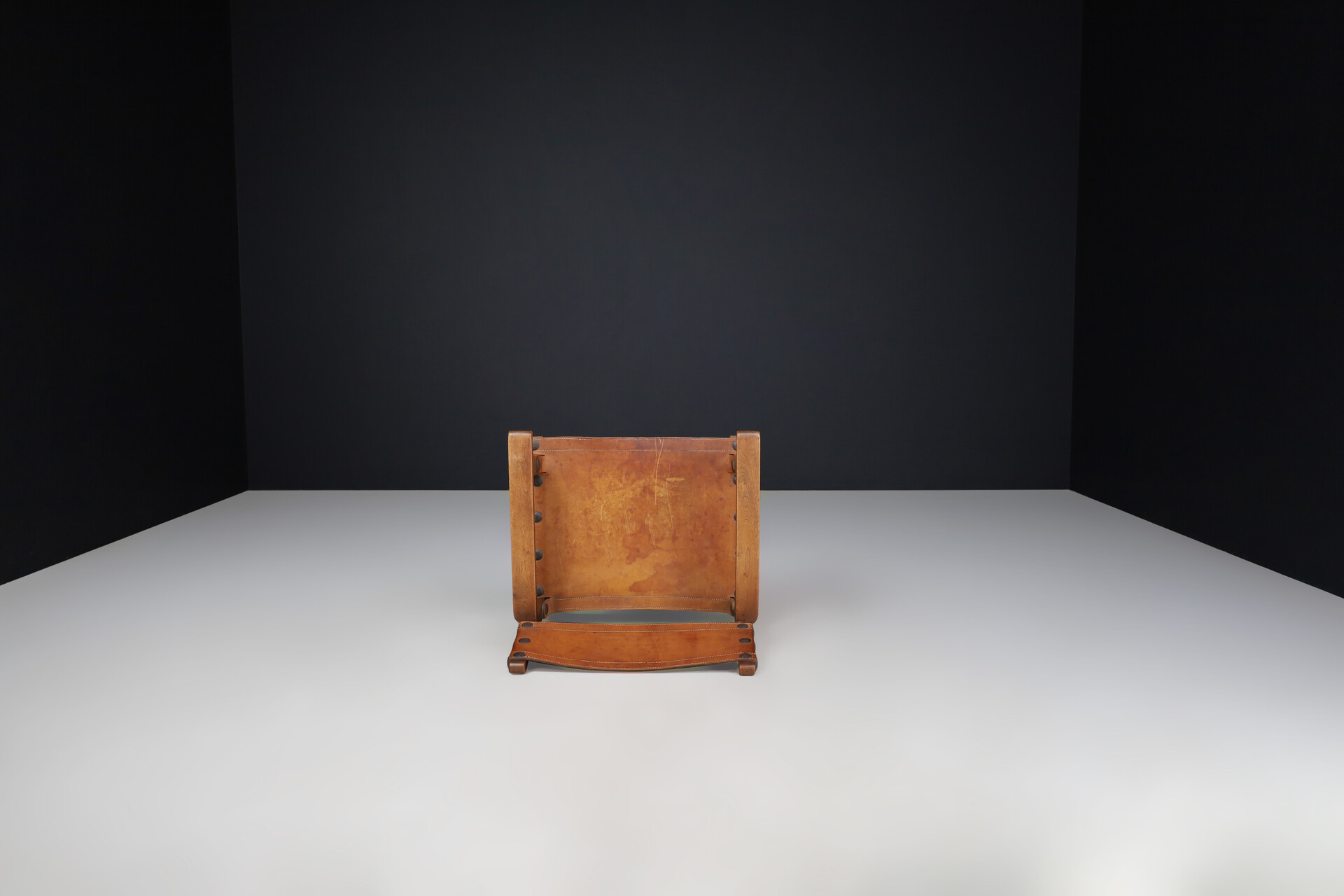Mid century modern Patinated cognac leather and wood lounge chair, France 1960s Mid-20th century