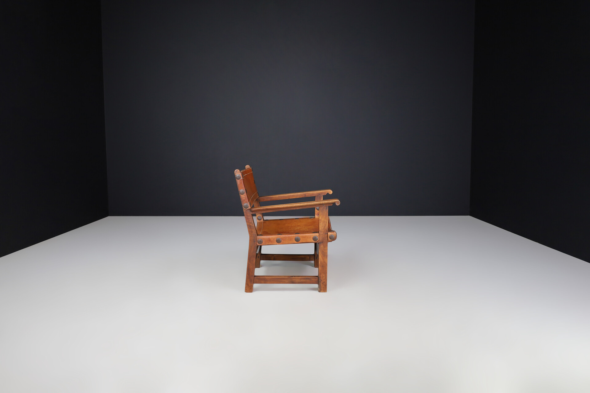 Mid century modern Patinated cognac leather and wood lounge chair, France 1960s Mid-20th century