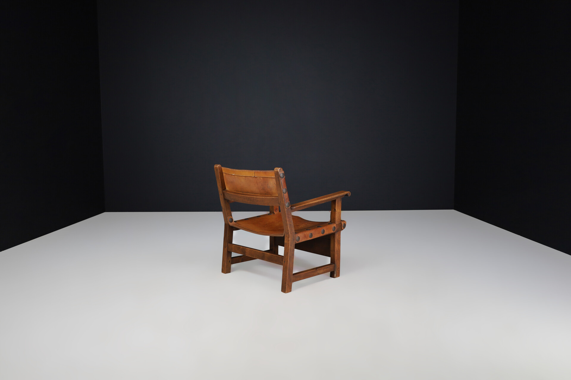 Mid century modern Patinated cognac leather and wood lounge chair, France 1960s Mid-20th century