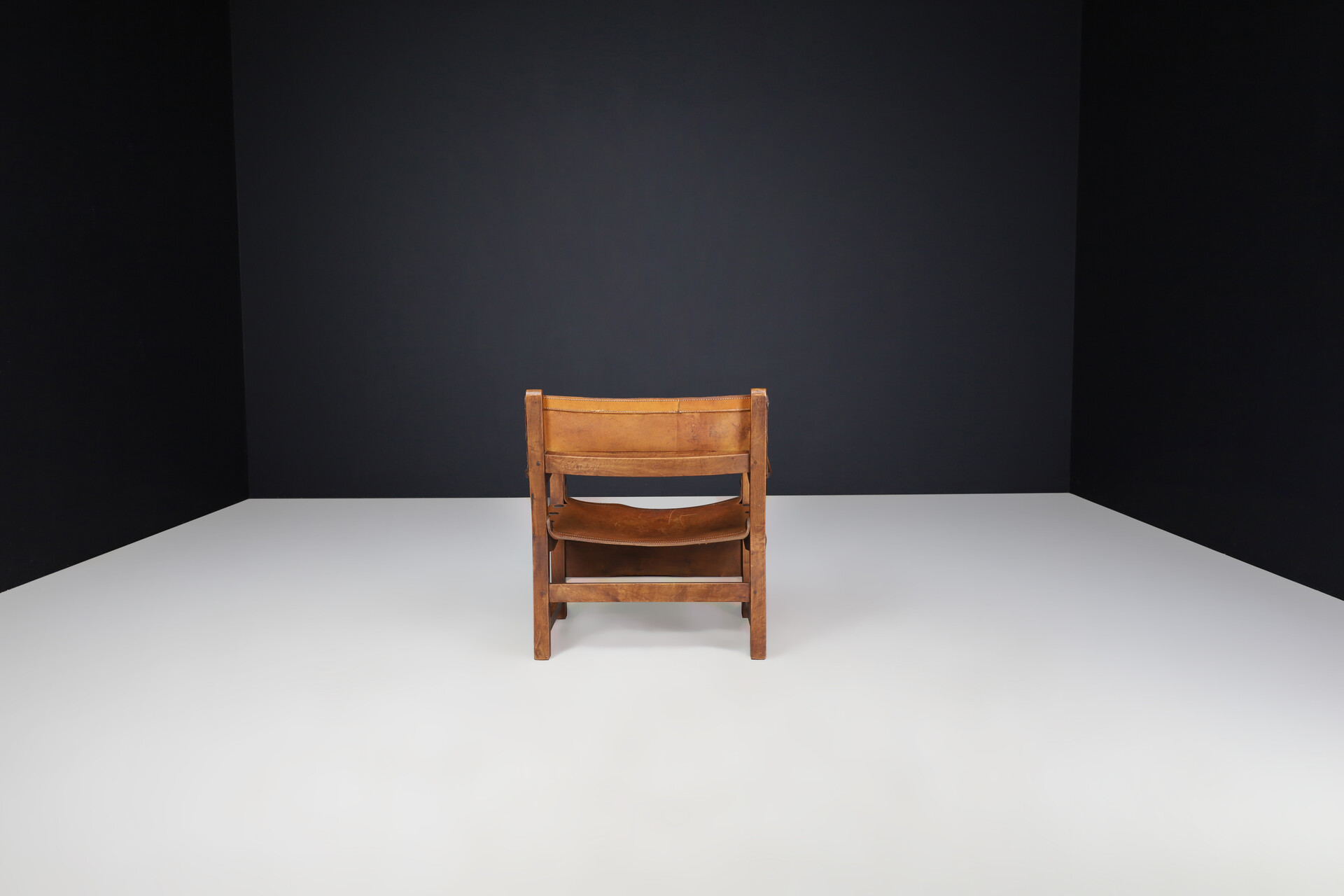 Mid century modern Patinated cognac leather and wood lounge chair, France 1960s Mid-20th century