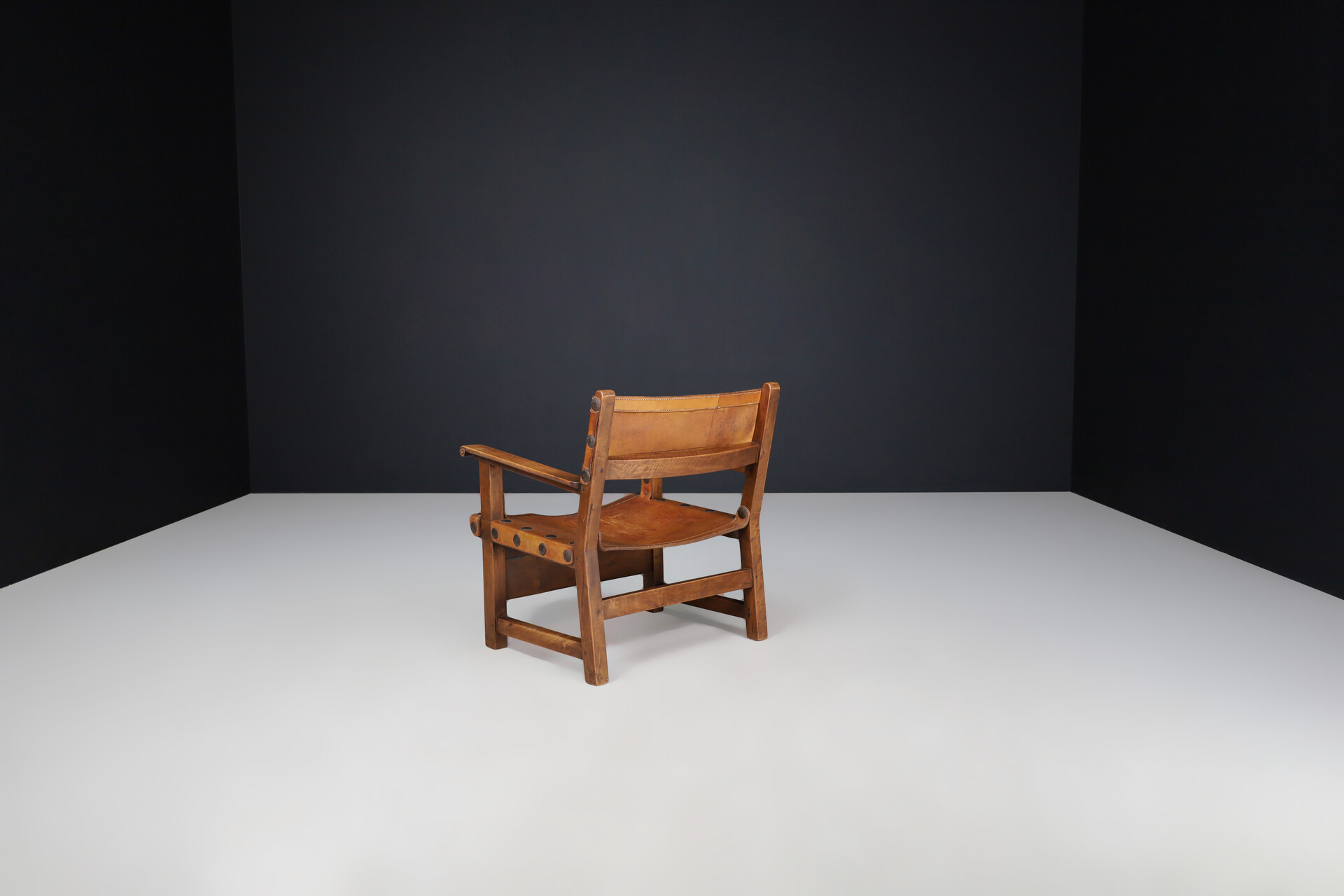 Mid century modern Patinated cognac leather and wood lounge chair, France 1960s Mid-20th century