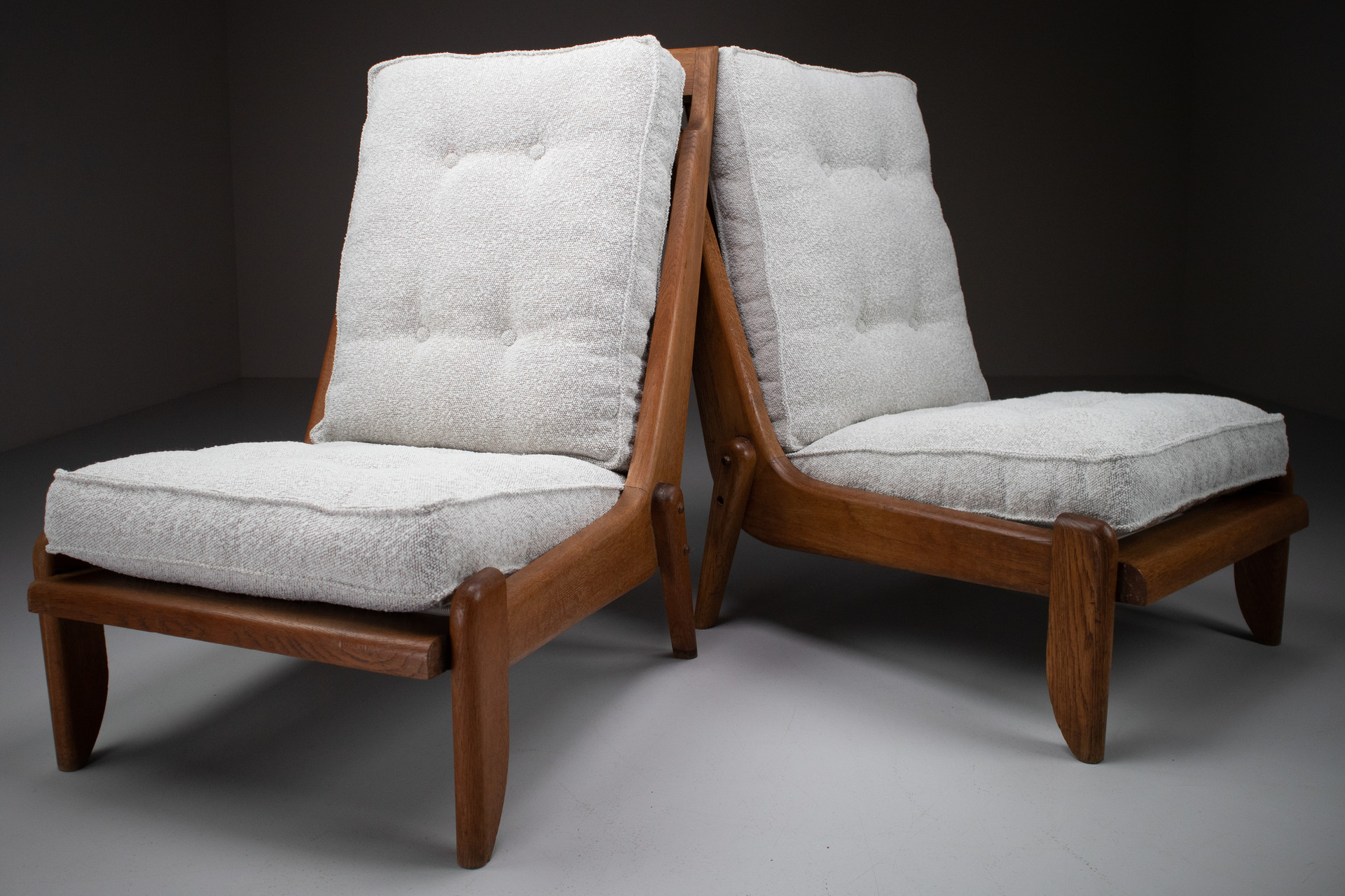 Pair Oak Lounge chairs by Guillerme & Chambron with newly upholstered cushions in boucle fabric , France, circa 1950 Mid-20th century