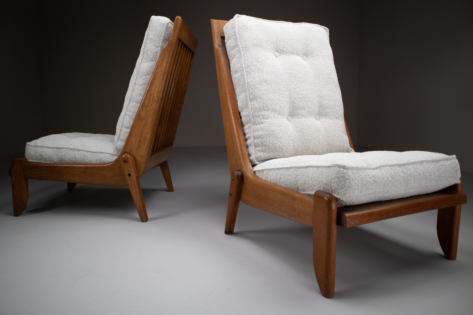 Pair Oak Lounge chairs by Guillerme & Chambron with newly upholstered cushions in boucle fabric , France, circa 1950 Mid-20th century