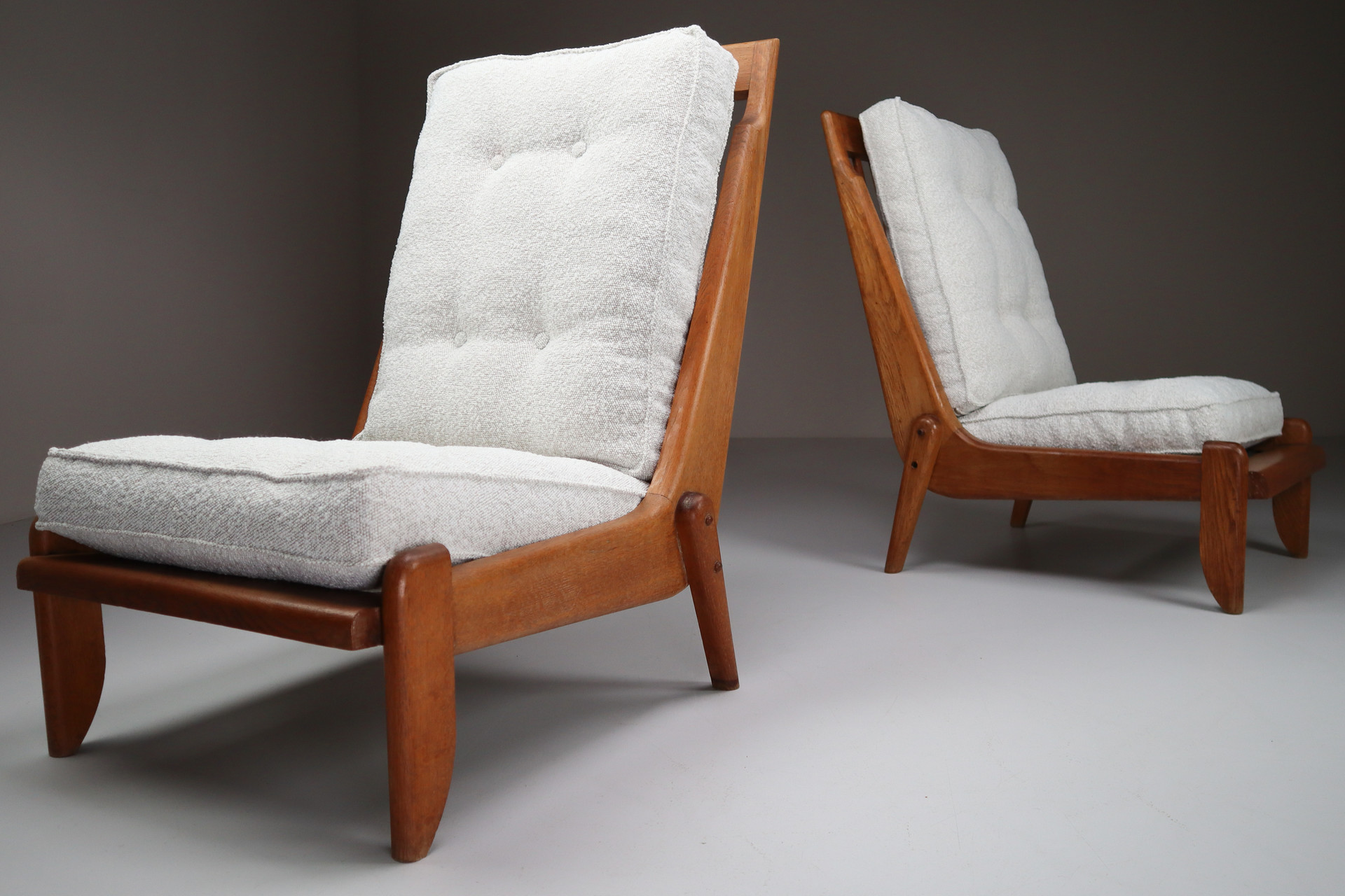 Pair Oak Lounge chairs by Guillerme & Chambron with newly upholstered cushions in boucle fabric , France, circa 1950 Mid-20th century