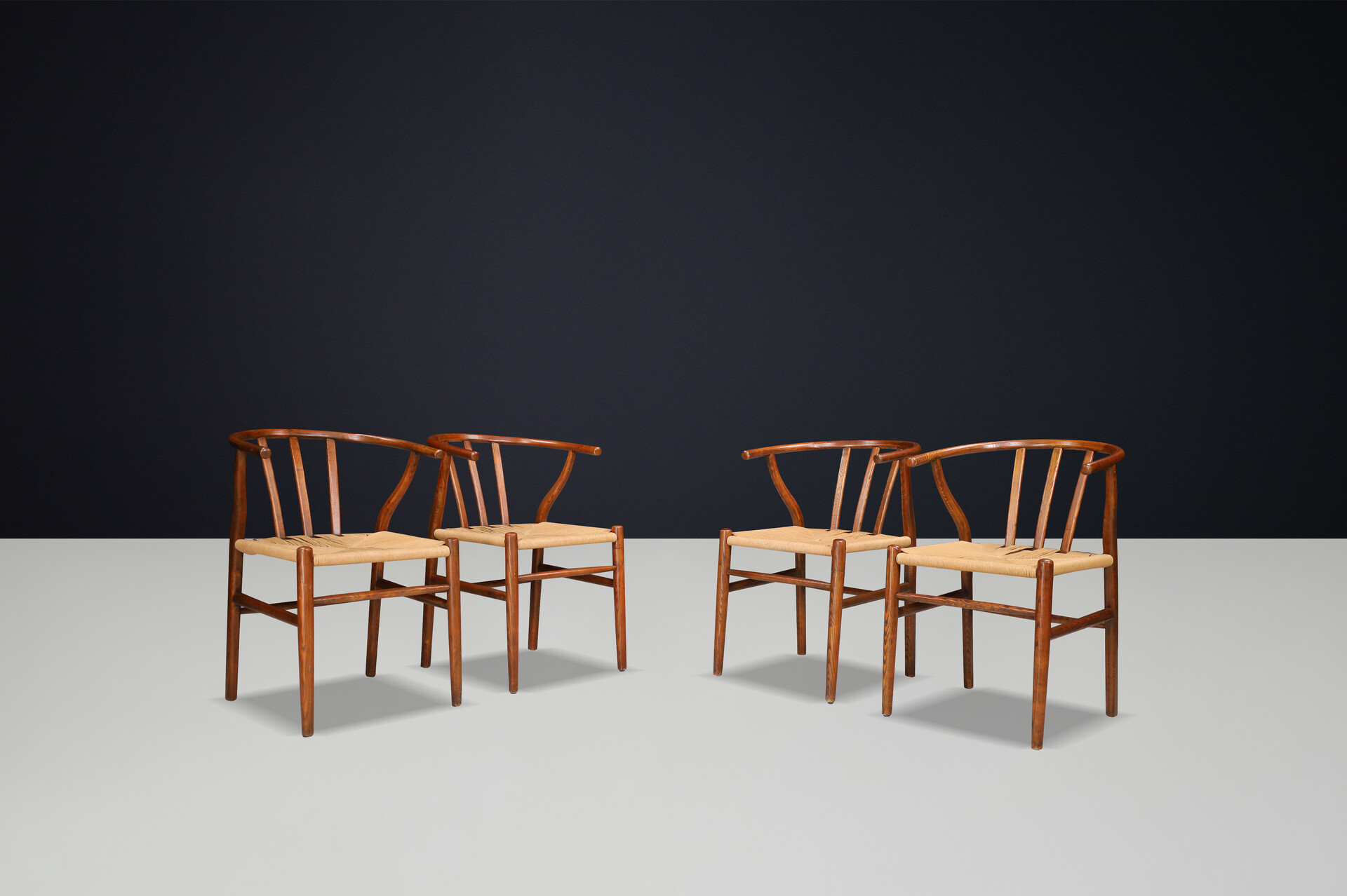 Scandinavian modern Wicker and Oak Arm chairs in the style of wishbone chair By Hans J. Wegner, Denmark 1960s Mid-20th century