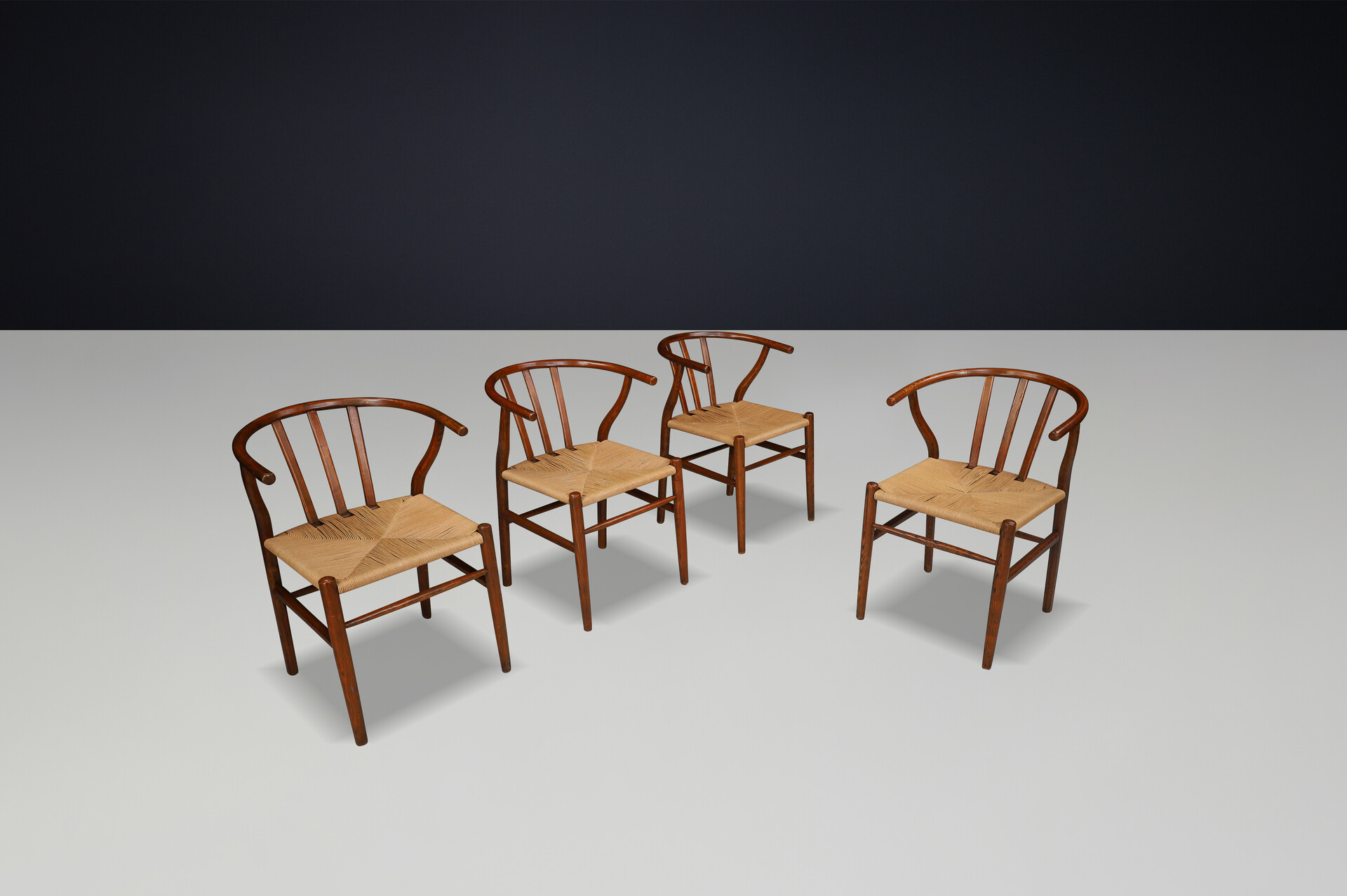 Scandinavian modern Wicker and Oak Arm chairs in the style of wishbone chair By Hans J. Wegner, Denmark 1960s Mid-20th century